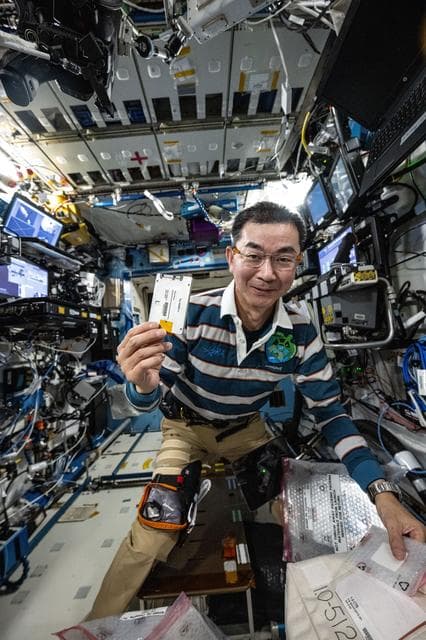 NASA image: JAXA astronaut Kimiya Yui shows off a research hard drive for an pharmaceutical investigation