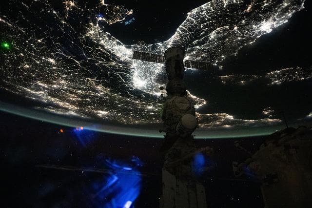 NASA image:  A faint blue-green airglow blankets Earth’s horizon above Italy