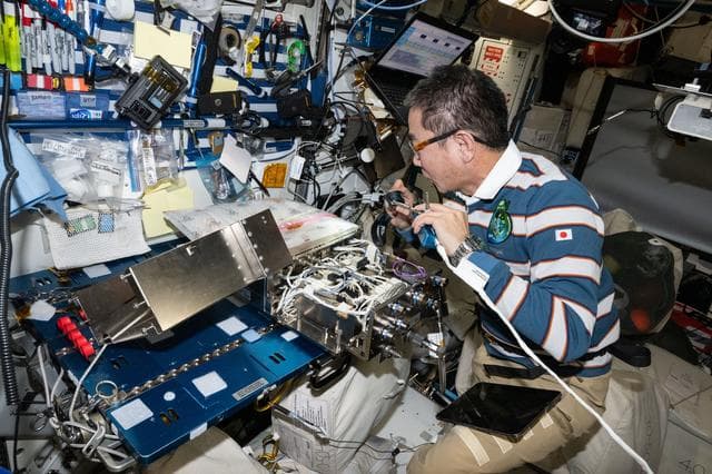 NASA image: JAXA astronaut Kimiya Yui works on computer networking hardware
