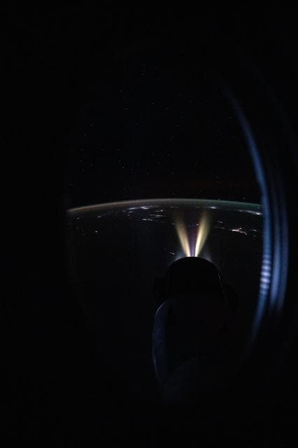 The Draco thrusters of the SpaceX Dragon cargo spacecraft fire during a reboost demonstration