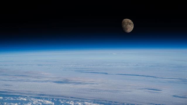 NASA image: The waxing gibbous Moon rises above Earth’s blue atmosphere