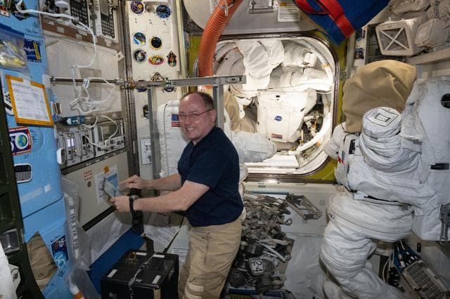 NASA image: NASA astronaut Mike Fincke performs maintenance tasks inside the Quest airlock