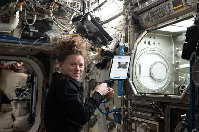 NASA image: NASA astronaut Zena Cardman installs research hardware inside the Microgravity Science Glovebox