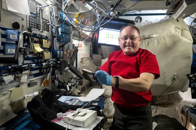 NASA image: NASA astronaut Mike Fincke smiles for a portrait while organizing cargo