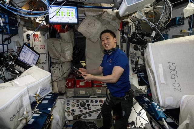 NASA image: NASA astronaut Jonny Kim smiles for a portrait whle organizing cargo