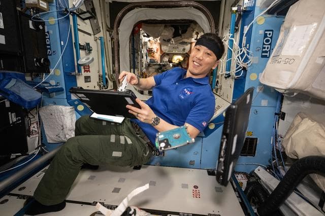 NASA image: NASA astronaut Jonny Kim performs laptop computer maintenance