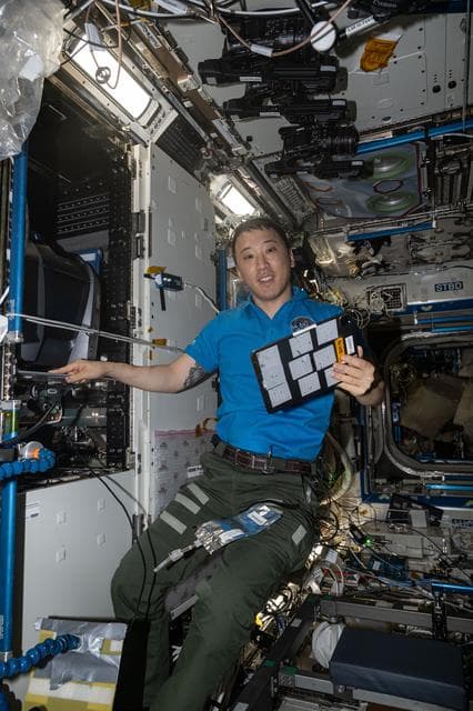 NASA image: NASA astronaut Jonny Kim poses for a portrait while servicing a fluorescence microscope