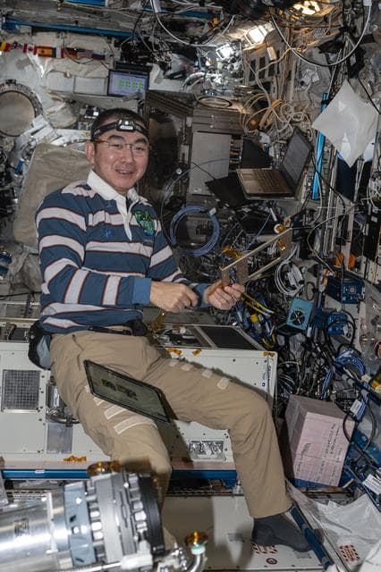 NASA image: JAXA astronaut Kimiya Yui assembles and installs carbon dioxide removal gear
