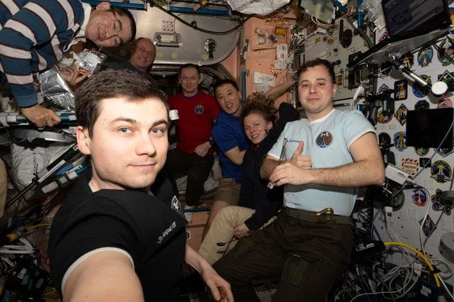 NASA image: The Expedition 73 crew gather for a portrait during dinnertime