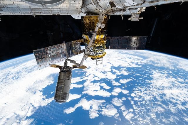 NASA image: The Cygnus XL cargo craft is pictured in the grips of the Canadarm2 robotic arm