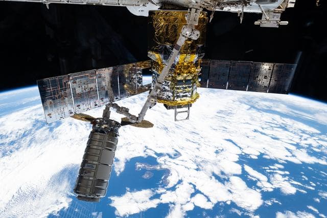 NASA image: The Cygnus XL cargo craft is pictured in the grips of the Canadarm2 robotic arm