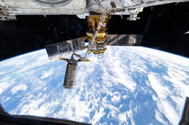 NASA image: The Cygnus XL cargo craft is pictured in the grips of the Canadarm2 robotic arm