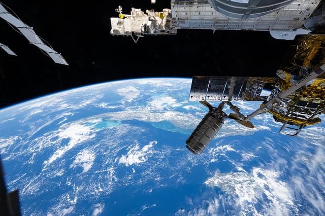 NASA image: The Cygnus XL cargo craft is pictured in the grips of the Canadarm2 robotic arm