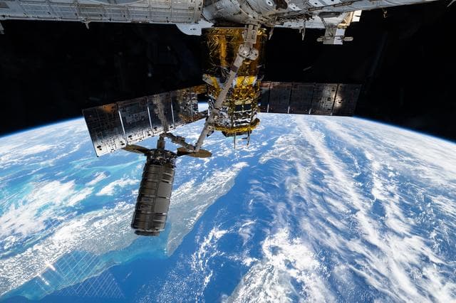 NASA image: The Cygnus XL cargo craft is pictured in the grips of the Canadarm2 robotic arm