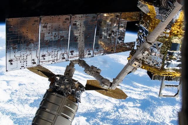NASA image: The Cygnus XL cargo craft is pictured in the grips of the Canadarm2 robotic arm