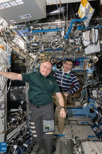 NASA image: Astronauts Mike Fincke and Kimiya Yui smile for a portrait