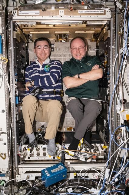 NASA image: Astronauts Kimiya Yui and Mike Fincke pose for a fun portrait