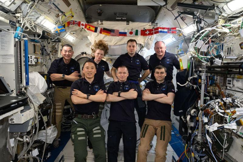 NASA image: The seven-member Expedition 73 crew gathers for a portrait inside the Kibo laboratory module