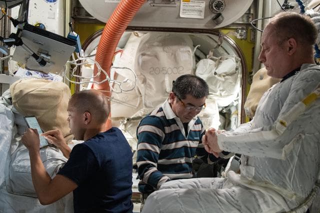 NASA image: Expedition 74 crew members participate in spacesuit check preparations
