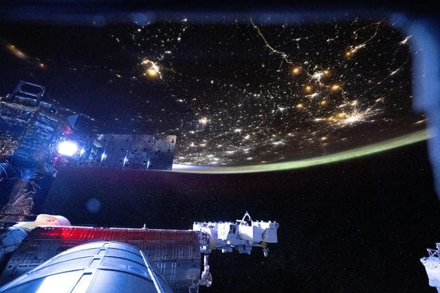NASA image: The International Space Station begins to shine brightly as it orbits into a sunrise