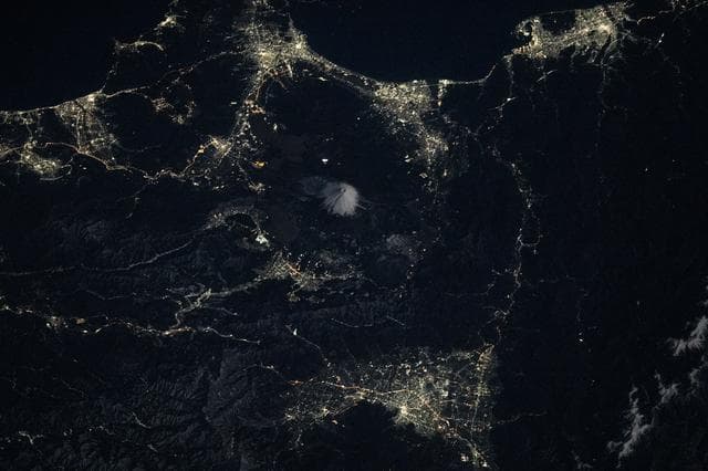 NASA image: Mount Fuji is surrounded by the city lights of the Fuji Five Lakes region