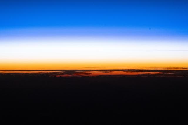 NASA image: An orbital sunset silhouettes the cloud tops above the Pacific Ocean