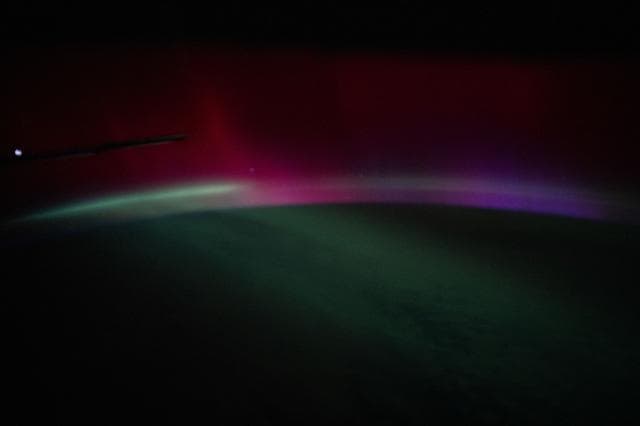 NASA image: A wispy, multi-colored aurora created by a geomagnetic storm