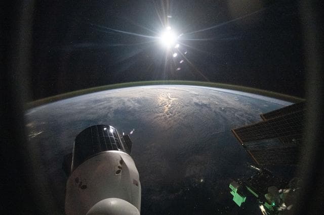 NASA image: The sun begins setting above Earth's atmospheric glow
