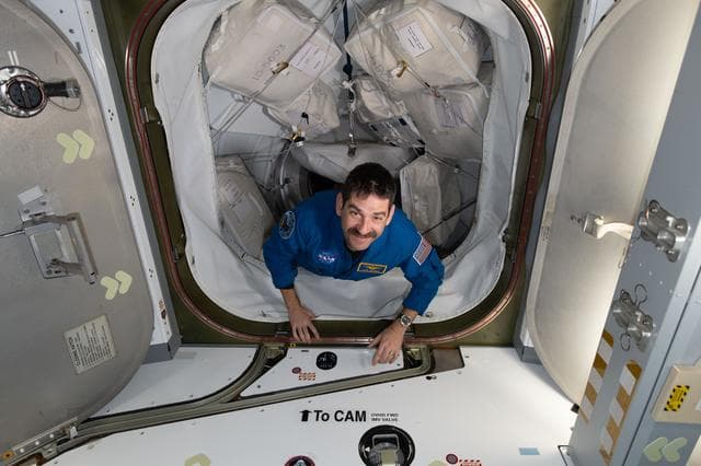NASA astronaut Jack Hathaway enters the International Space Station