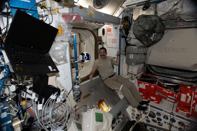 NASA image: NASA astronaut Jack Hathaway monitors a free‑flying robotic camera