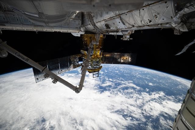 NASA image: The HTV-X1 cargo craft and the Canadarm2 robotic arm
