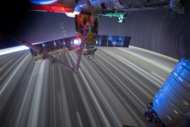 NASA image: Star trails and city lights streak as the International Space Station orbits Earth