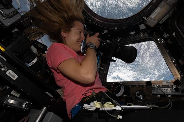 NASA image: ESA astronaut Sophie Adenot points a camera out a cupola window