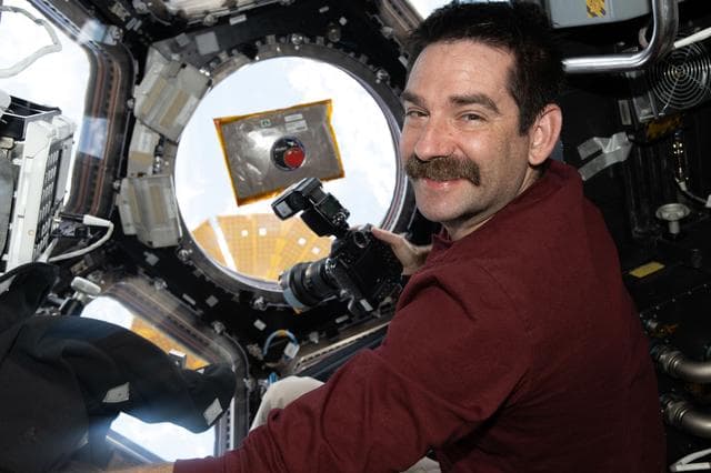 NASA image: NASA astronaut Jack Hathaway smiles for a portrait inside the International Space Station’s cupola