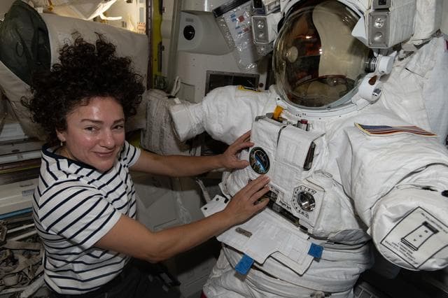 NASA image: NASA astronaut Jessica Meir works on a spacesuit inside the Quest airlock