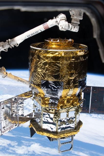 NASA image: The HTV‑X1 cargo spacecraft is in the grasp of the Canadarm2 robotic arm