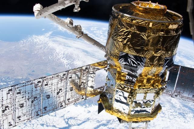 NASA image: The HTV‑X1 cargo spacecraft is in the grasp of the Canadarm2 robotic arm
