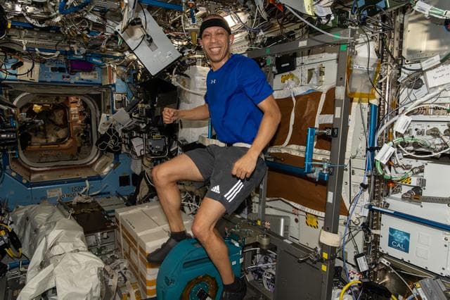 NASA image: NASA astronaut Chris Williams pedals on the exercise cycle inside the Destiny laboratory module