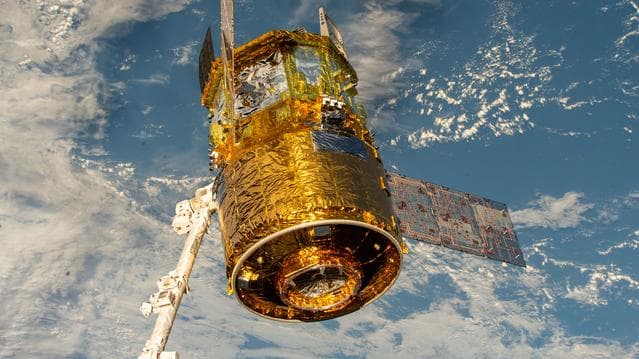 NASA image: The HTV‑X1 cargo spacecraft from JAXA is grasped by the Canadarm2 robotic arm