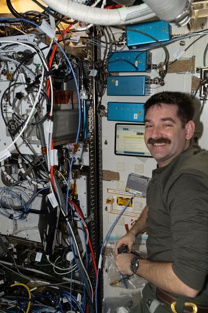 NASA image: NASA astronaut Jack Hathaway checks the operation of the Exploration Potable Water Dispenser