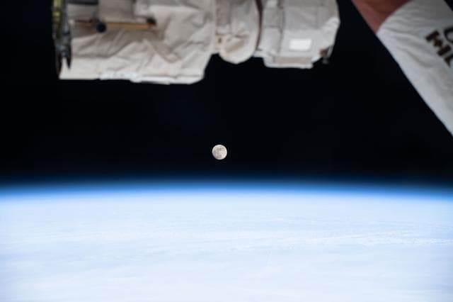 NASA image: A waxing gibbous Moon is pictured above Earth's atmosphere