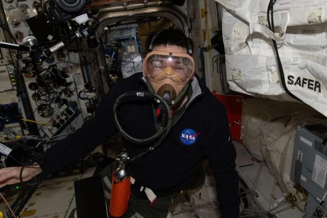 NASA image: NASA astronaut Jack Hathaway wears a portable breathing apparatus