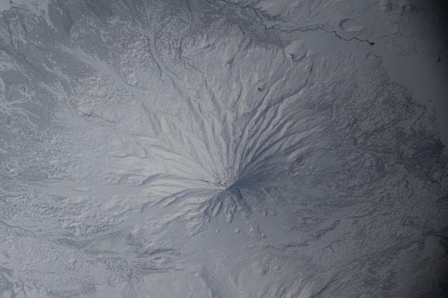 NASA image: The snow‑covered Kronotsky, a major stratovolcano on the Kamchatka Peninsula in Russia