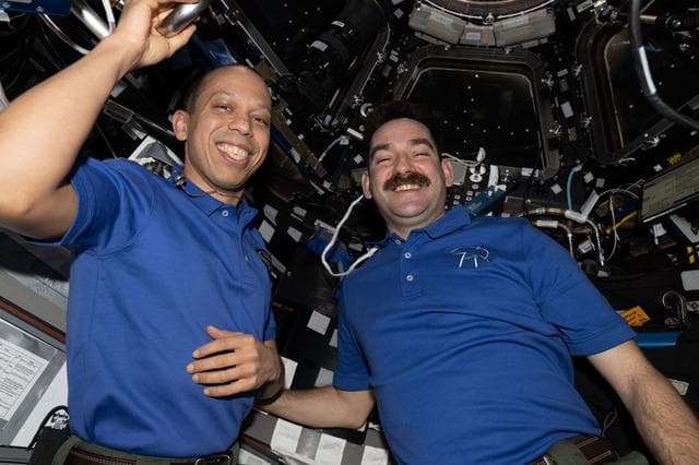 NASA image: NASA astronauts Chris Williams and Jack Hathaway pose for a portrait inside the cupola