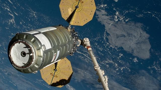 NASA image: The Cygnus XL cargo spacecraft is held in the grips of the Canadarm2 robotic arm