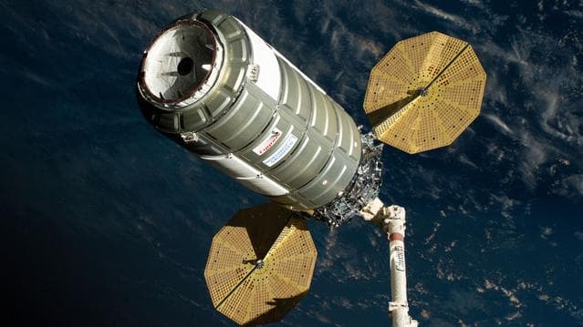 NASA image: The Cygnus XL cargo spacecraft is held in the grips of the Canadarm2 robotic arm