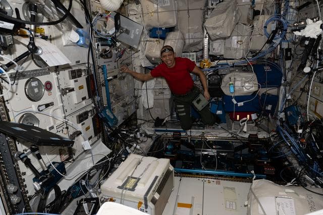NASA image: NASA astronaut Chris Williams unpacks computer hardware that supports new exercise gear