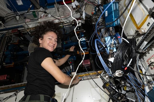 NASA image: NASA astronaut Jessica Meir replaces components on a new exercise device