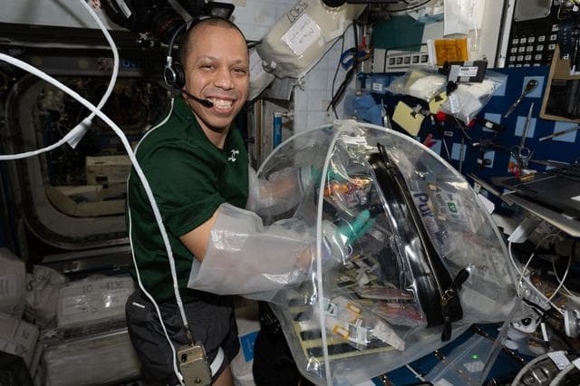 NASA image: NASA astronaut Chris Williams configures research hardware for a biotechnology investigation