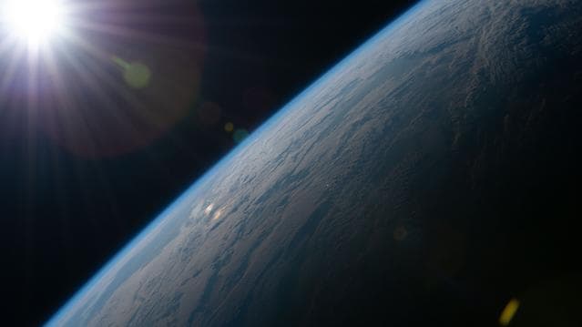 NASA image: The Sun begins illuminating Earth’s surface just after an orbital sunrise